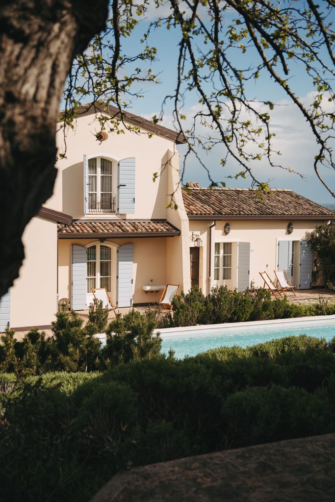 Cozy bedroom with garden view at Borgo Condé, decorated in country style.