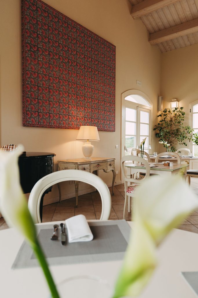 Rustic restaurant interior at Borgo Condé featuring traditional furnishings.